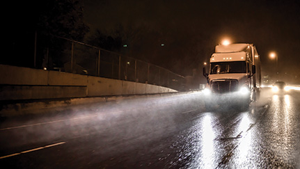 Semi truck driving at night